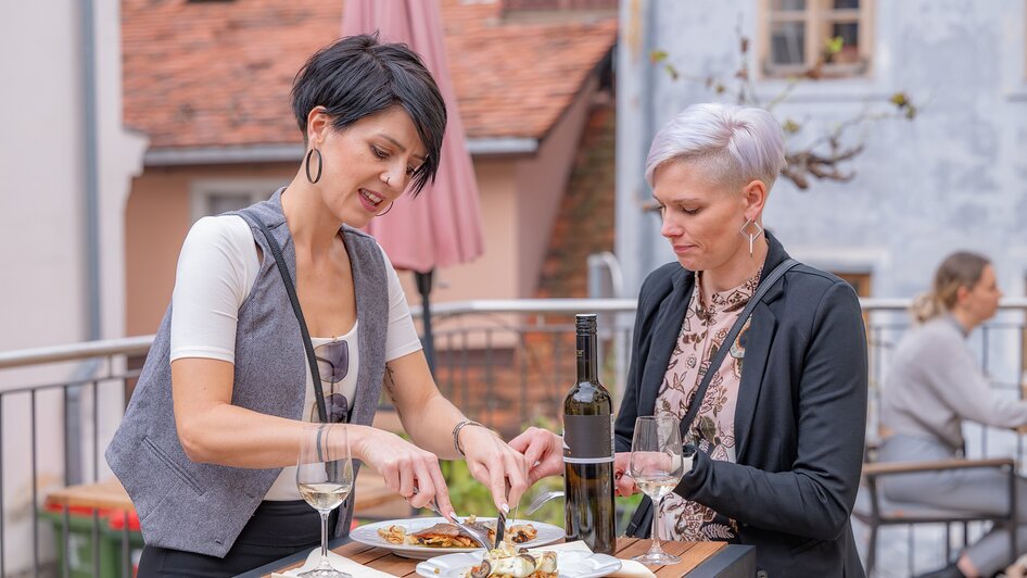 Zwei Frauen genießen das Essen und Wein im Freien bei Gut Schlossberg in Graz. | © 5komma5sinne - Rene Strasser Fotografie