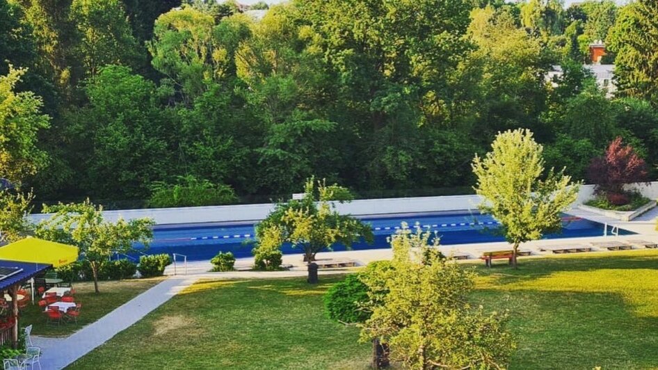 Blick auf das Ragnitzbad mit Pool und Grünflächen in Graz.