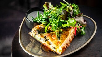 Ein Stück Quiche mit frischem Salat und Dressing auf einem Teller. | © Ristorante Trenta